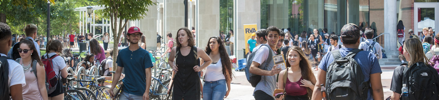Students walking together outside of the library in the courtyard